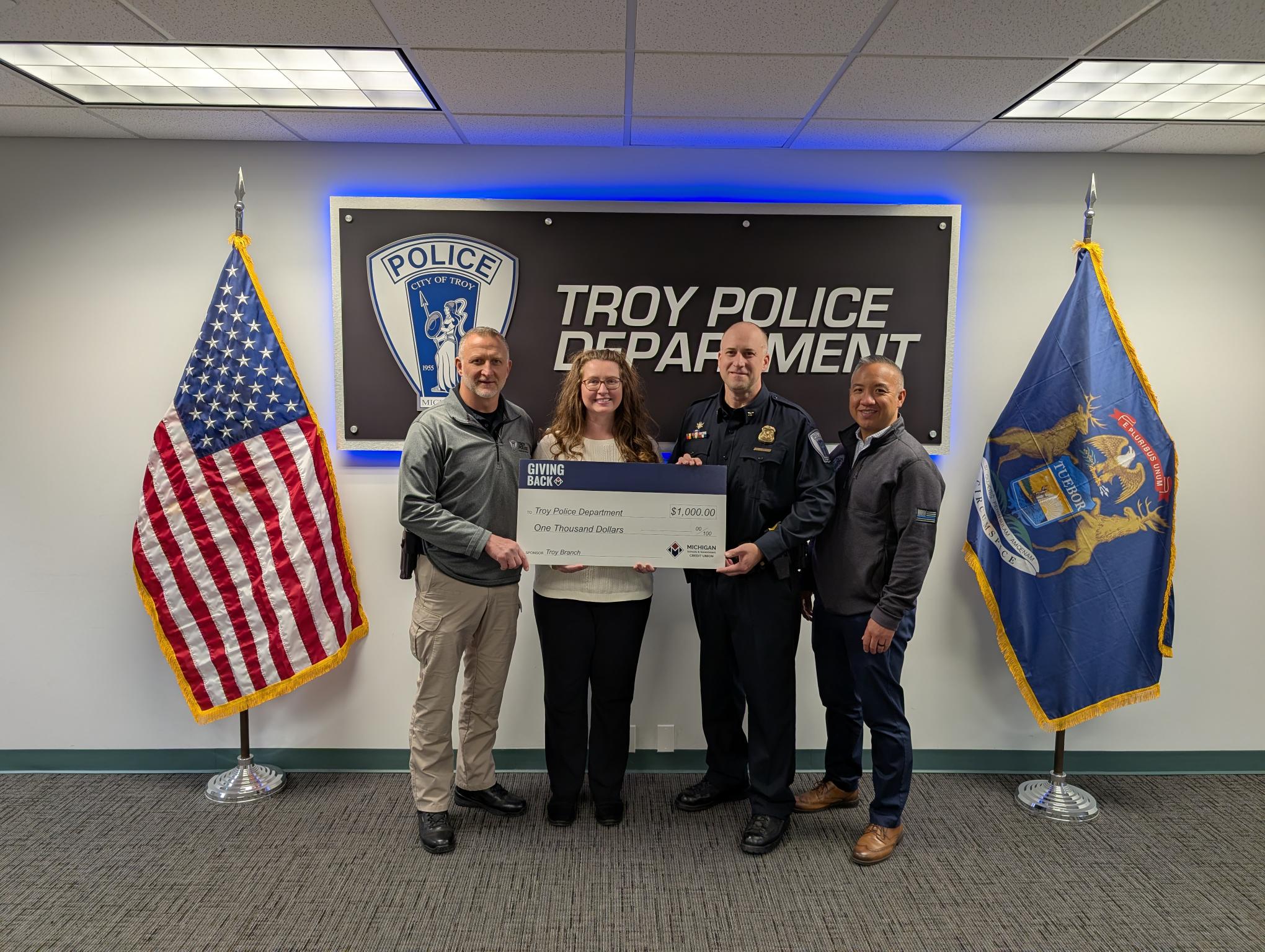 Troy team members present MSGCU's Giving Back donation to the Troy Police Department.